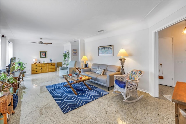 living room featuring speckled floor, visible vents, and ceiling fan