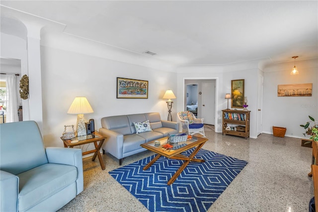 living room with visible vents, speckled floor, and baseboards