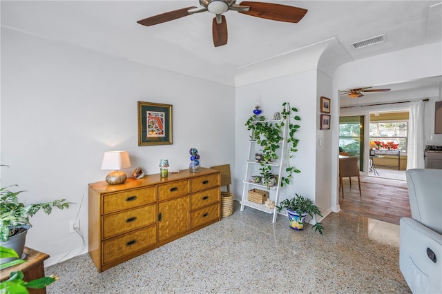 interior space with visible vents, stacked washing maching and dryer, ceiling fan, and speckled floor