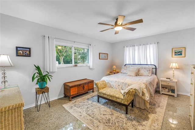 bedroom with a ceiling fan and baseboards