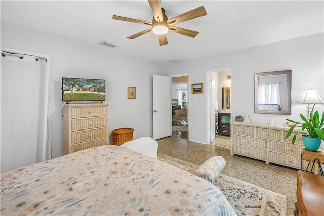 bedroom featuring visible vents, speckled floor, and ceiling fan