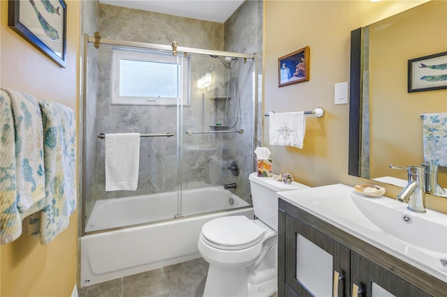 full bathroom with vanity, toilet, bath / shower combo with glass door, and tile patterned flooring