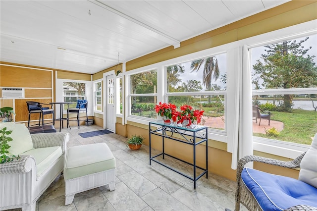 sunroom / solarium featuring vaulted ceiling with beams