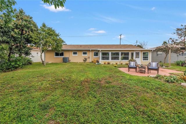 rear view of house featuring stucco siding, a patio, fence, a yard, and central AC unit