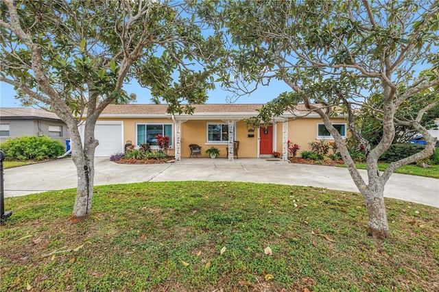 single story home featuring stucco siding, a garage, concrete driveway, and a front yard