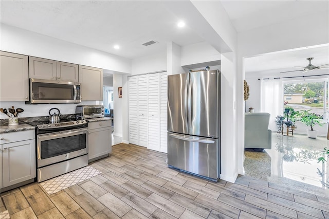4322 22nd Ave N, Saint Petersburg, FL 33713 - kitchen with appliances with stainless steel finishes, gray cabinets, wood finish floors, and recessed lighting