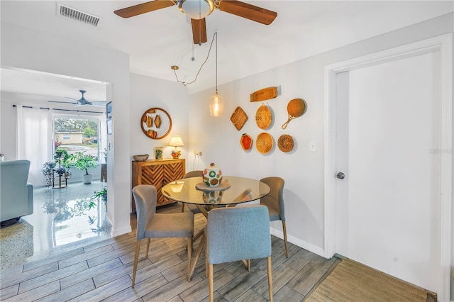 4322 22nd Ave N, Saint Petersburg, FL 33713 - dining room with a ceiling fan, light wood finished floors, and baseboards