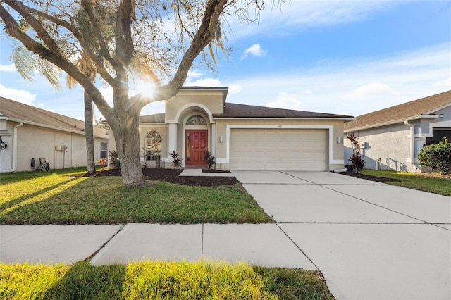 view of front facade featuring a garage, driveway, a front lawn, and stucco siding