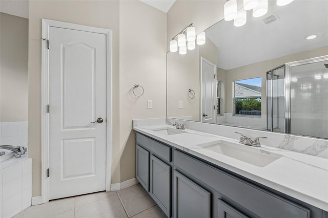 bathroom featuring a stall shower, tile patterned flooring, visible vents, and a sink