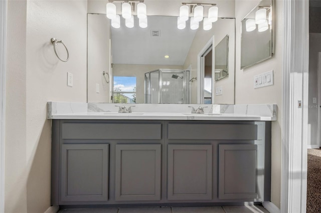 full bathroom with double vanity, a sink, visible vents, and a shower stall