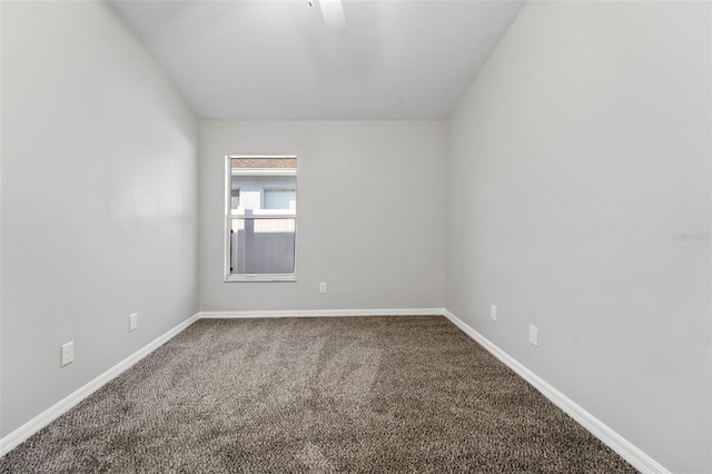 carpeted spare room with baseboards