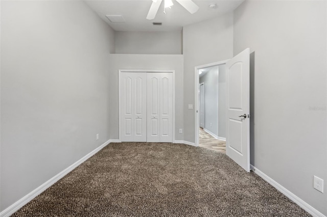 unfurnished bedroom featuring visible vents, baseboards, a ceiling fan, carpet, and a closet