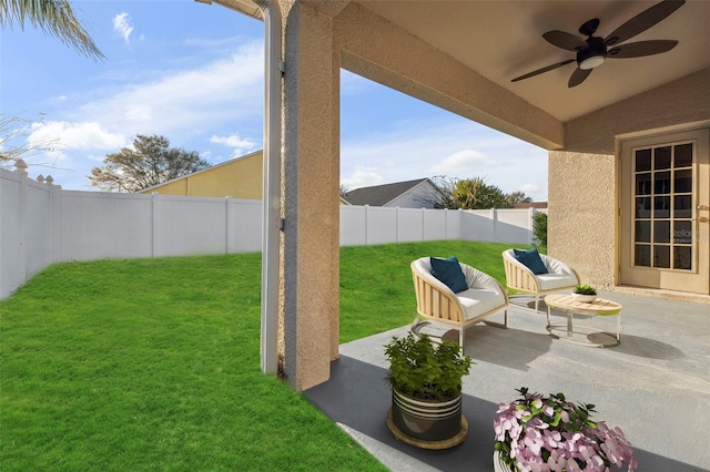 view of yard featuring a patio area, a fenced backyard, and a ceiling fan