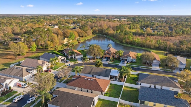 bird's eye view featuring a water view, a forest view, and a residential view