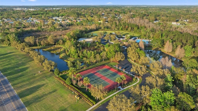 drone / aerial view featuring a water view and a view of trees