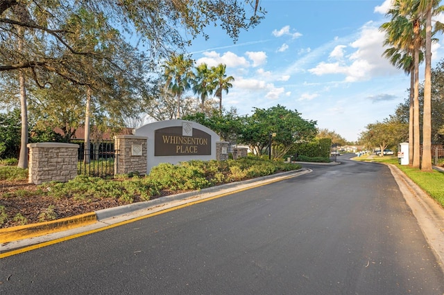 view of road featuring curbs and a gated entry