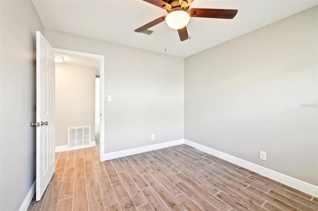 unfurnished room featuring light wood-style flooring, visible vents, ceiling fan, and baseboards