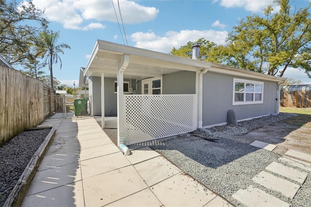 exterior space featuring fence and stucco siding