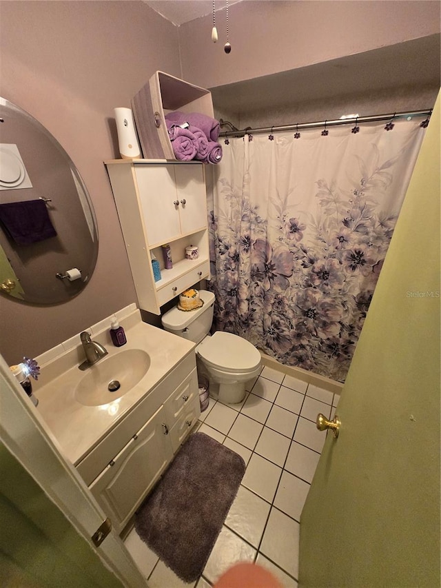 bathroom featuring tile patterned flooring, a shower with shower curtain, vanity, and toilet