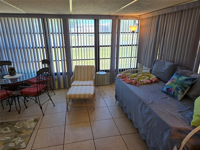 bedroom featuring light tile patterned flooring and a textured ceiling