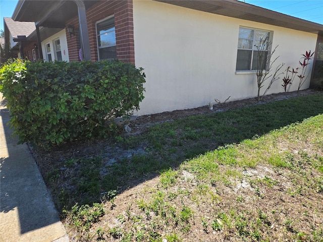 view of property exterior featuring a yard and stucco siding