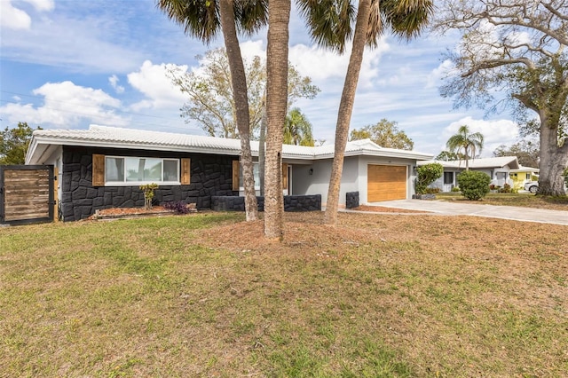 single story home featuring stucco siding, an attached garage, stone siding, driveway, and a front lawn