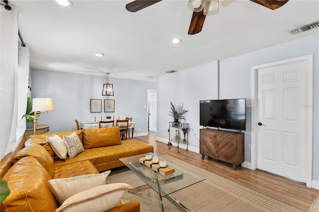 living room with a ceiling fan, light wood-type flooring, visible vents, and recessed lighting