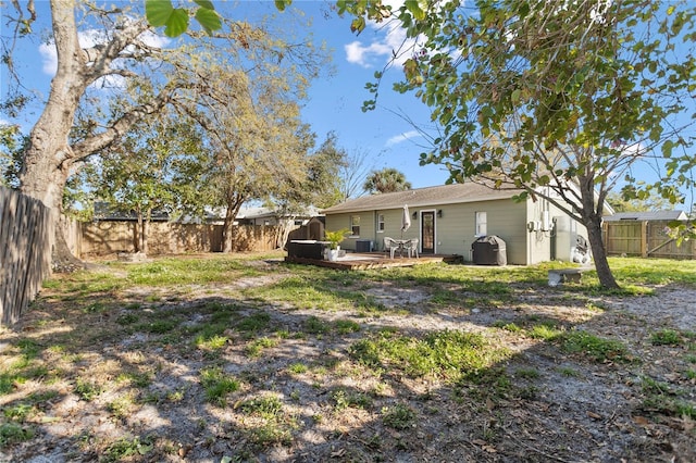 view of yard with a fenced backyard and a wooden deck