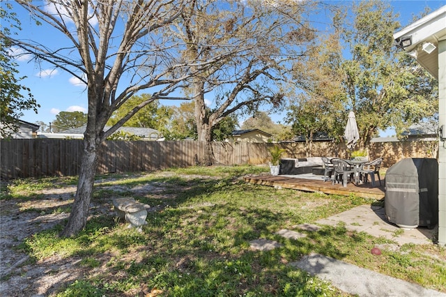 view of yard with a fenced backyard, a wooden deck, and an outdoor hangout area