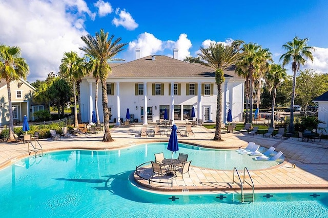 pool featuring a patio and fence