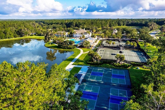 birds eye view of property with a forest view and a water view