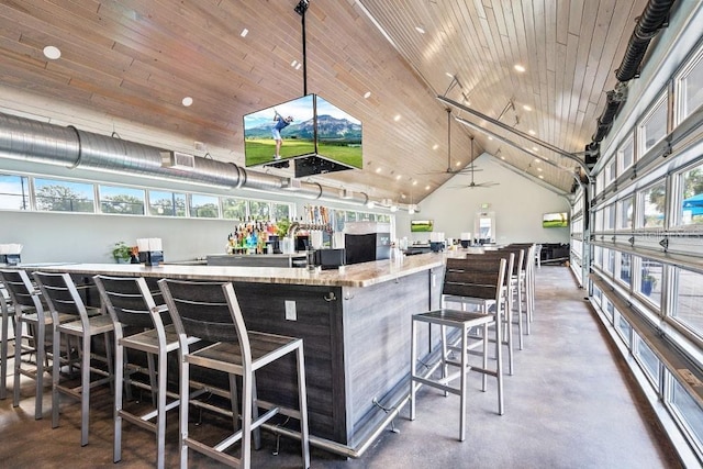 bar with a bar, wood ceiling, high vaulted ceiling, and decorative light fixtures