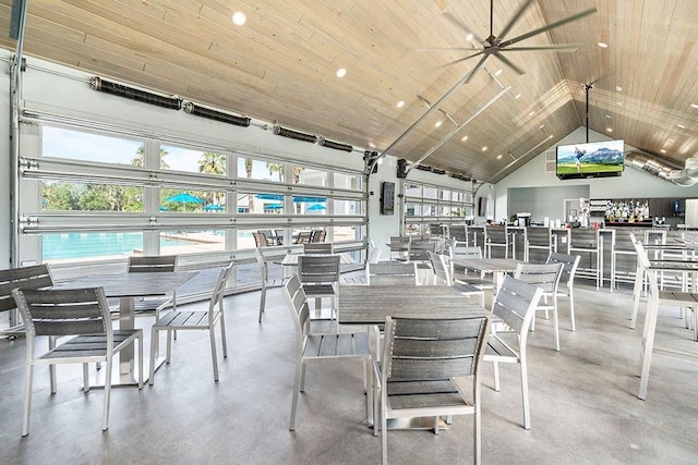 dining room featuring concrete flooring, high vaulted ceiling, wood ceiling, and recessed lighting