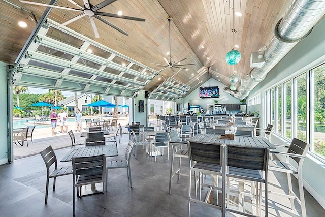 dining area with a healthy amount of sunlight, wooden ceiling, ceiling fan, and vaulted ceiling