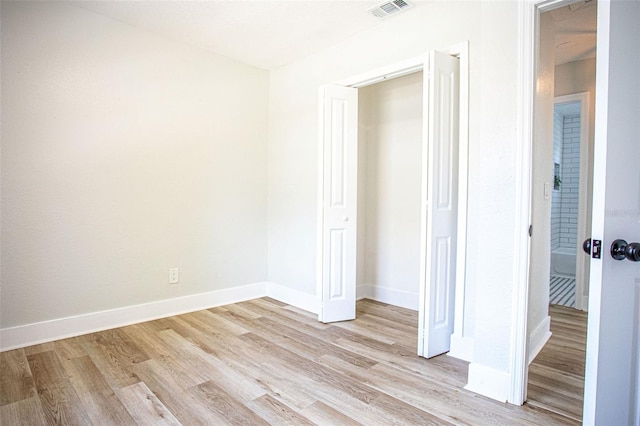 unfurnished bedroom with light wood-type flooring, baseboards, and visible vents