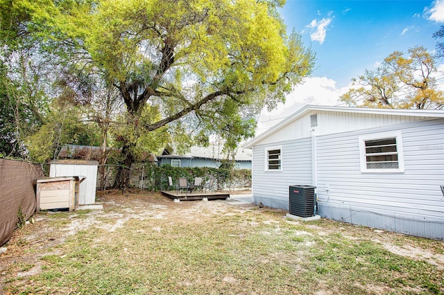 view of yard with cooling unit, fence, and a wooden deck