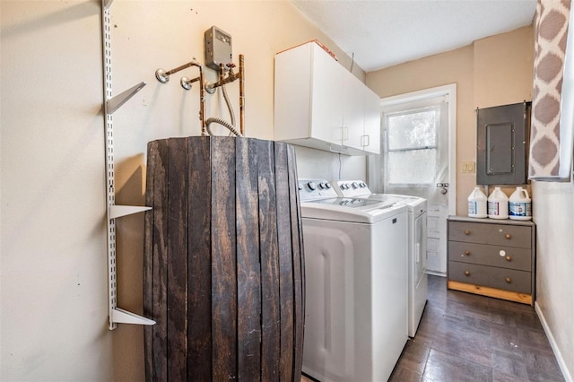 laundry area with separate washer and dryer, cabinet space, electric panel, and baseboards