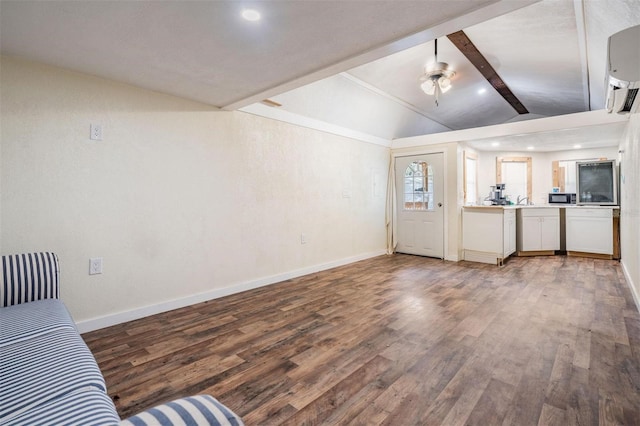 living room featuring ceiling fan, lofted ceiling with beams, baseboards, and wood finished floors