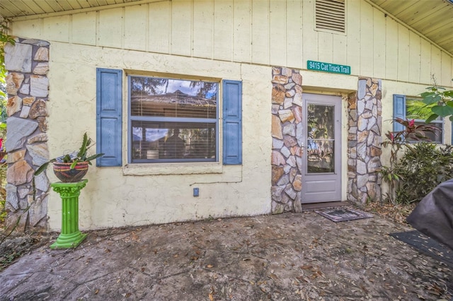 view of exterior entry featuring stone siding