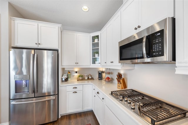 kitchen with appliances with stainless steel finishes, light countertops, and white cabinetry