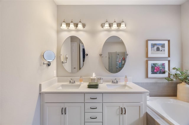 bathroom with a shower with door, a sink, a garden tub, and double vanity