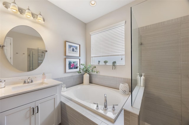 bathroom featuring tiled shower, vanity, and a bath