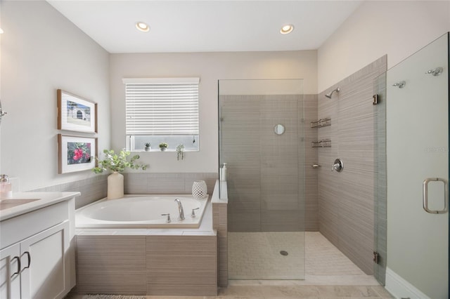 bathroom featuring recessed lighting, a garden tub, a shower stall, and vanity