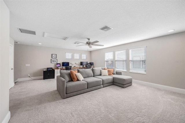 living area featuring light carpet, attic access, and visible vents