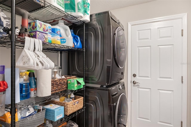 clothes washing area featuring laundry area and stacked washer and dryer