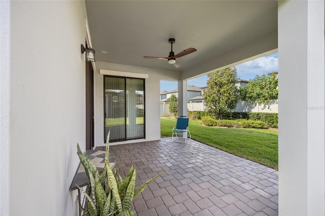 view of patio with ceiling fan and fence