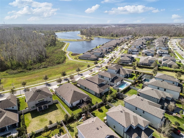 birds eye view of property featuring a water view, a residential view, and a forest view