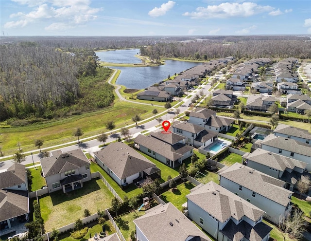 aerial view featuring a water view, a residential view, and a forest view