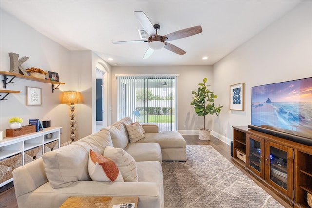 living room featuring a ceiling fan, visible vents, wood finished floors, baseboards, and recessed lighting