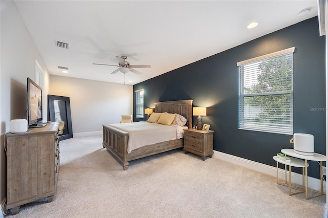 bedroom featuring visible vents, baseboards, recessed lighting, light colored carpet, and a ceiling fan